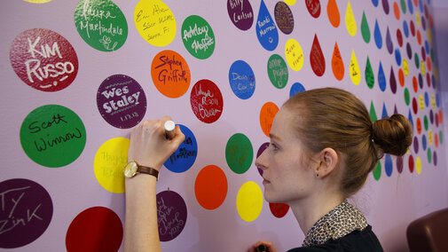 woman writing on wall in a circle