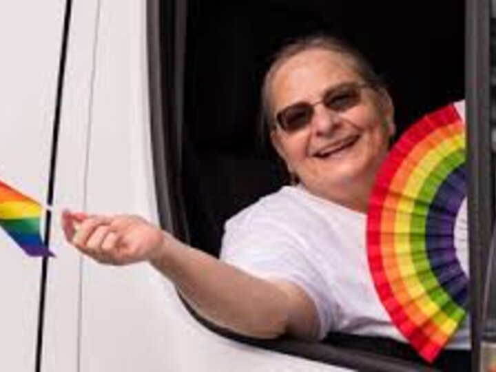 pat Tetreault waving pride flag